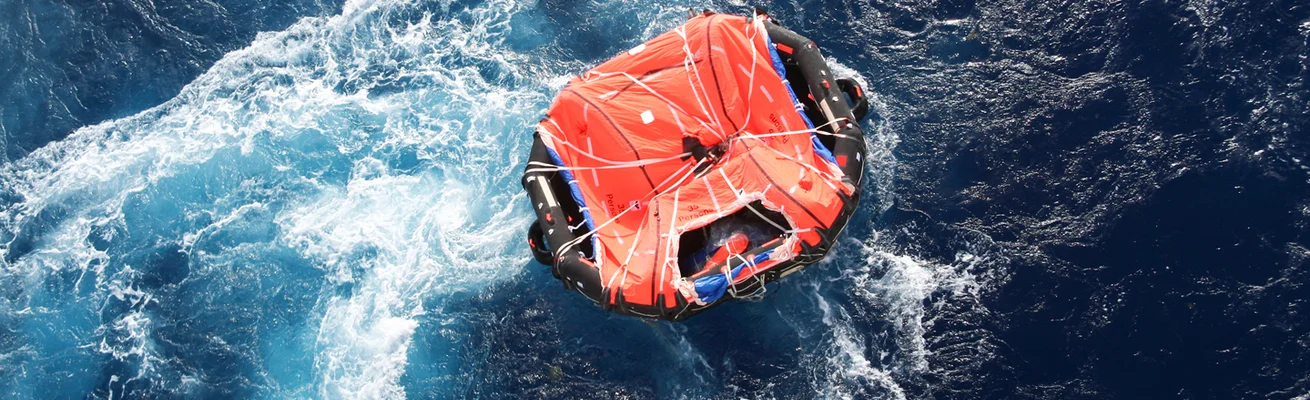 Floßboot auf See in Wellen während maritimer Ausbildung, Schulung und Sicherheitstraining.