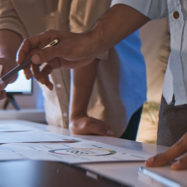 ESG team pointing at papers on the table to discuss
